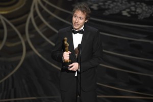 Laszlo Nemes, of Hungary, accepts the award for best foreign language film for Son of Saul at the Oscars on Sunday, Feb. 28, 2016, at the Dolby Theatre in Los Angeles. (Photo by Chris Pizzello/Invision/AP)